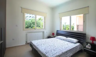 a bedroom with a bed and two windows at Michelle 8 in Protaras