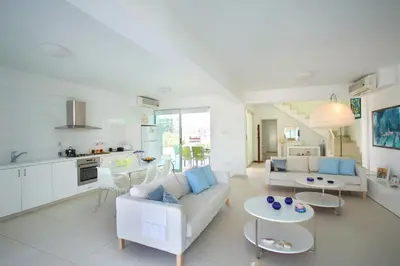 a living room with a couch and a table at Architect's Villa in Protaras