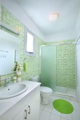 a bathroom with a sink and a toilet and a shower at Architect's Villa in Protaras
