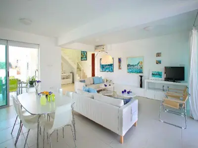 a living room with a couch and a table at Architect's Villa in Protaras