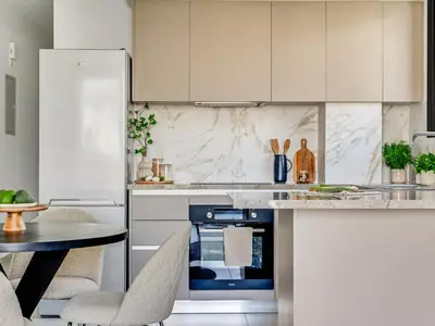 a kitchen with white cabinets and a blue oven at Sanders Triple in Limassol