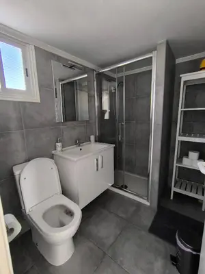 a bathroom with a toilet and a shower at Julie's beach house in Voroklini