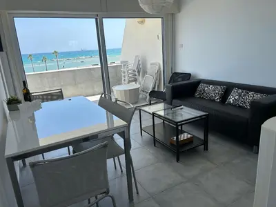 a living room with a couch and a table at Julie's beach house in Voroklini