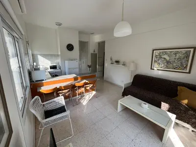 a living room with a couch and a table at Themis Beach Apartments in Larnaka