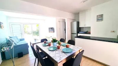 a kitchen and dining room with a table and chairs at Dream Escape Apt 1 - 6 min walk to Kastella Beach! in Larnaka