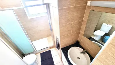 a small bathroom with a toilet and a sink at Dream Escape Apt 1 - 6 min walk to Kastella Beach! in Larnaka