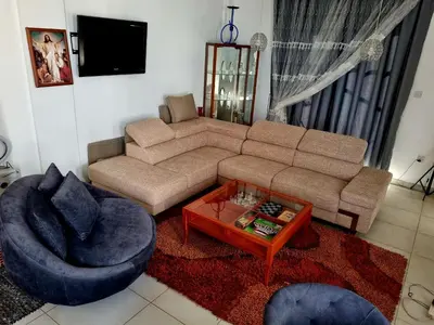 a living room with a couch and a table at Impeccable 3-Bed Villa in Nicosia in Yukarı Lakatamya