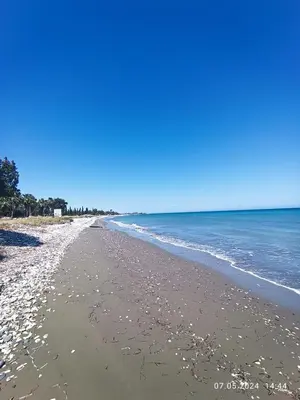 a sandy beach with the ocean in the background at Ferienhaus_FamilyKrausz in Pervolia