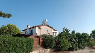 a house with a chimney on top of it at Ferienhaus_FamilyKrausz in Pervolia