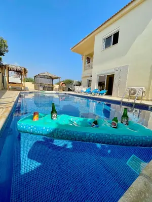 a swimming pool with an inflatable tub in the middle of a house at Mediterranean Breeze Villa in Protaras