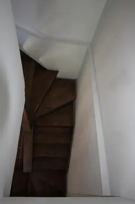 a wooden staircase in a room with a white ceiling at River House in Kakopetria
