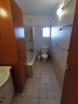 a bathroom with a toilet and a tub and a sink at Oroklini Hideaway in Voroklini