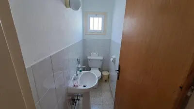 a small bathroom with a sink and a toilet at Manors Seaside 2BR House 100m from the Beach & Free Parking in Meneou