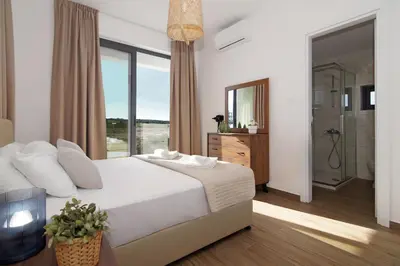 a bedroom with a large bed and a large window at Villa Celestia in Protaras