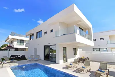 a villa with a swimming pool and a house at Villa Genesis in Protaras