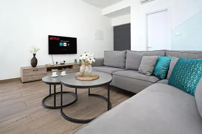 a living room with a couch and a table at Villa Genesis in Protaras