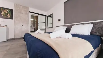 a bedroom with a large blue bed with white pillows at Nissi avenue 64 Studio 3 - Luxcyservices in Ayia Napa