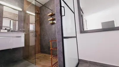 a bathroom with a shower and a glass door at Nissi avenue 64 Studio 3 - Luxcyservices in Ayia Napa