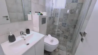 a bathroom with a sink and a toilet and a shower at STAY Napa Aura Apartment in Ayia Napa