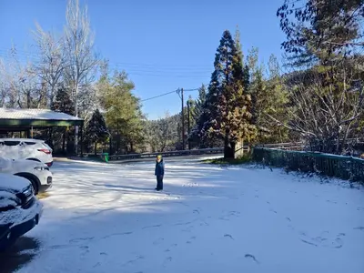 a person standing in the middle of a snow covered street at Rifugio Retreat in Kakopetria