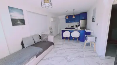 a living room with a couch and a kitchen at STAY Monte Elias Apartment in Protaras