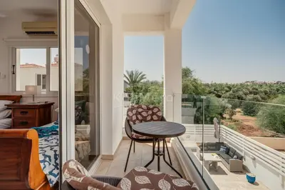 a room with a balcony with a table and chairs at Villa Maddie in Protaras