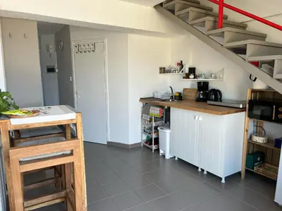 a kitchen with a counter and a staircase in a room at Endless Sunset in Pendakomo