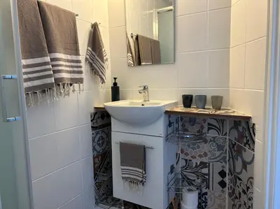 a bathroom with a sink and a mirror at Endless Sunset in Pendakomo