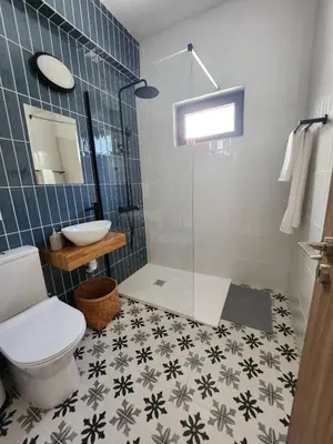 a bathroom with a shower and a toilet and a sink at Adamandri Lodge - Prime Location in Ayia Napa