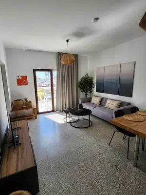 a living room with a couch and a table at Adamandri Lodge - Prime Location in Ayia Napa
