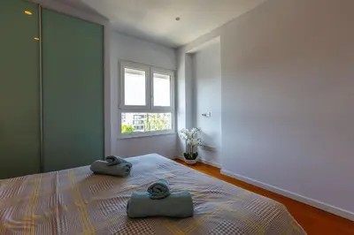 a bedroom with a bed with two towels on it at Modern seafront apartment in Limassol