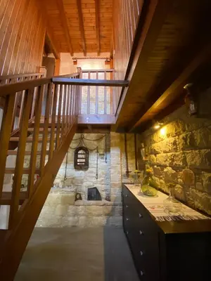 a staircase in a room with a stone wall at Lofitiko in Lofou
