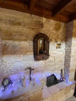 a stone bathroom with a sink and a mirror at Lofitiko in Lofou
