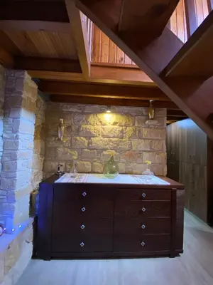 a wooden dresser in a room with a brick wall at Lofitiko in Lofou