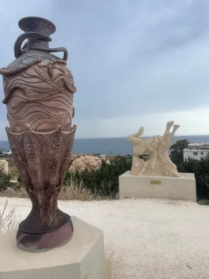 a statue of a vase with a hat on it at Viking Family Superior Lux in Ayia Napa
