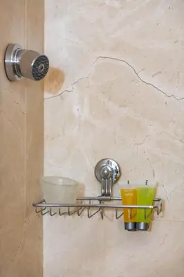 a shelf in a bathroom with some dishes on it at Quattro Beachfront Sea View Ap 4 in Larnaka