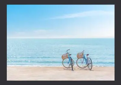 two bikes parked on the beach near the ocean at Zima Two Seaside in Zygi