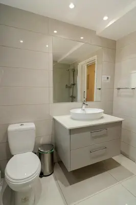 a bathroom with a toilet and a sink at Finikoudes 3 Bedroom Seaview Flat in Larnaka