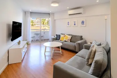 a living room with a couch and a table at Finikoudes 3 Bedroom Seaview Flat in Larnaka