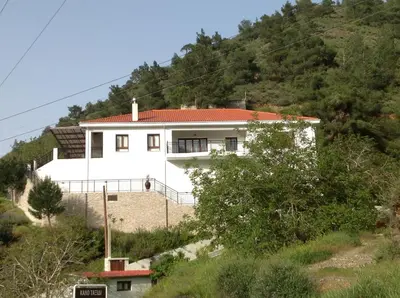 a white house on the side of a hill at Ta Spitakia tis Theodosias in Kalopanayiotis