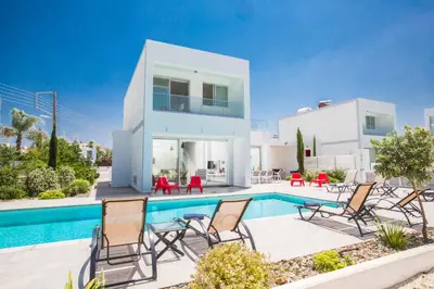 a villa with a swimming pool in front of a house at Protaras Greco Villa CCV1 in Protaras