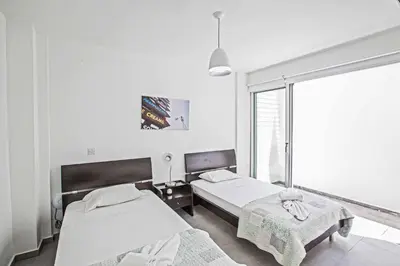 a bedroom with two beds and a window at Protaras Greco Villa CCV1 in Protaras