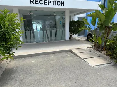 an entrance to a building with a sign that reads reception at Number 10 @ Coralli in Protaras