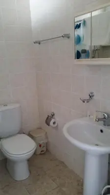 a bathroom with a toilet and a sink at Pelides Apartments in Larnaka