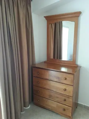 a dresser with a mirror on top of it at St. Lazaros House in Larnaka