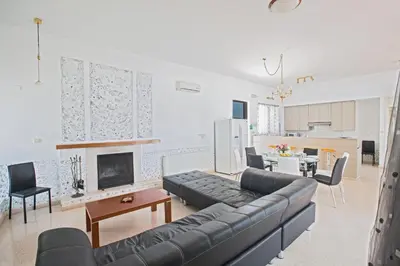 a living room with a couch and a fireplace at Napa Nissi House in Ayia Napa