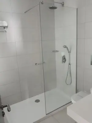 a shower with a glass door in a bathroom at Vrissaki Beach Hotel in Protaras