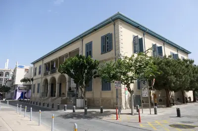 a building on a street with trees in front of it at Chariandry Residence, Limassol City Centre in Limassol