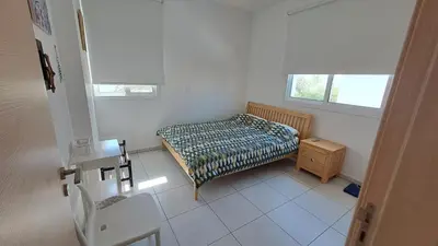 a small bedroom with a bed and a table at Relaxing Avra Villa with Private Pool & Garden Near Protaras in Paralimni