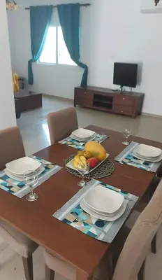 a dining room table with plates and fruit on it at The T Villa in Protaras